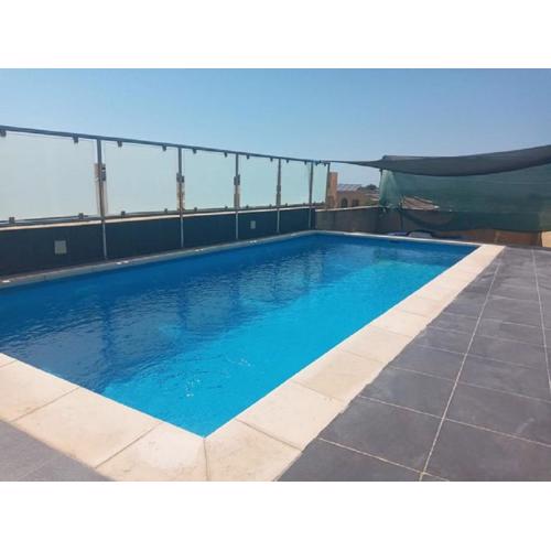 Cauchi corner house with roof top pool