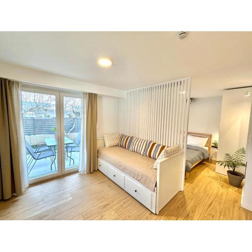 Minimalist Seaside Apartment with Private Patio and Parking
