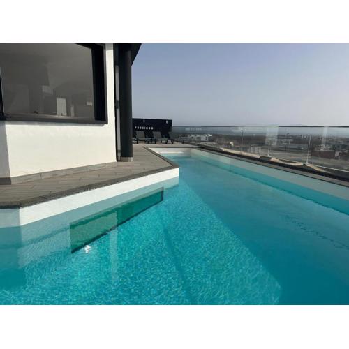 Villa Poseidon Corralejo with Private Heated Pool, Sauna and Stunning Volcano Views by Amazzzing Travel